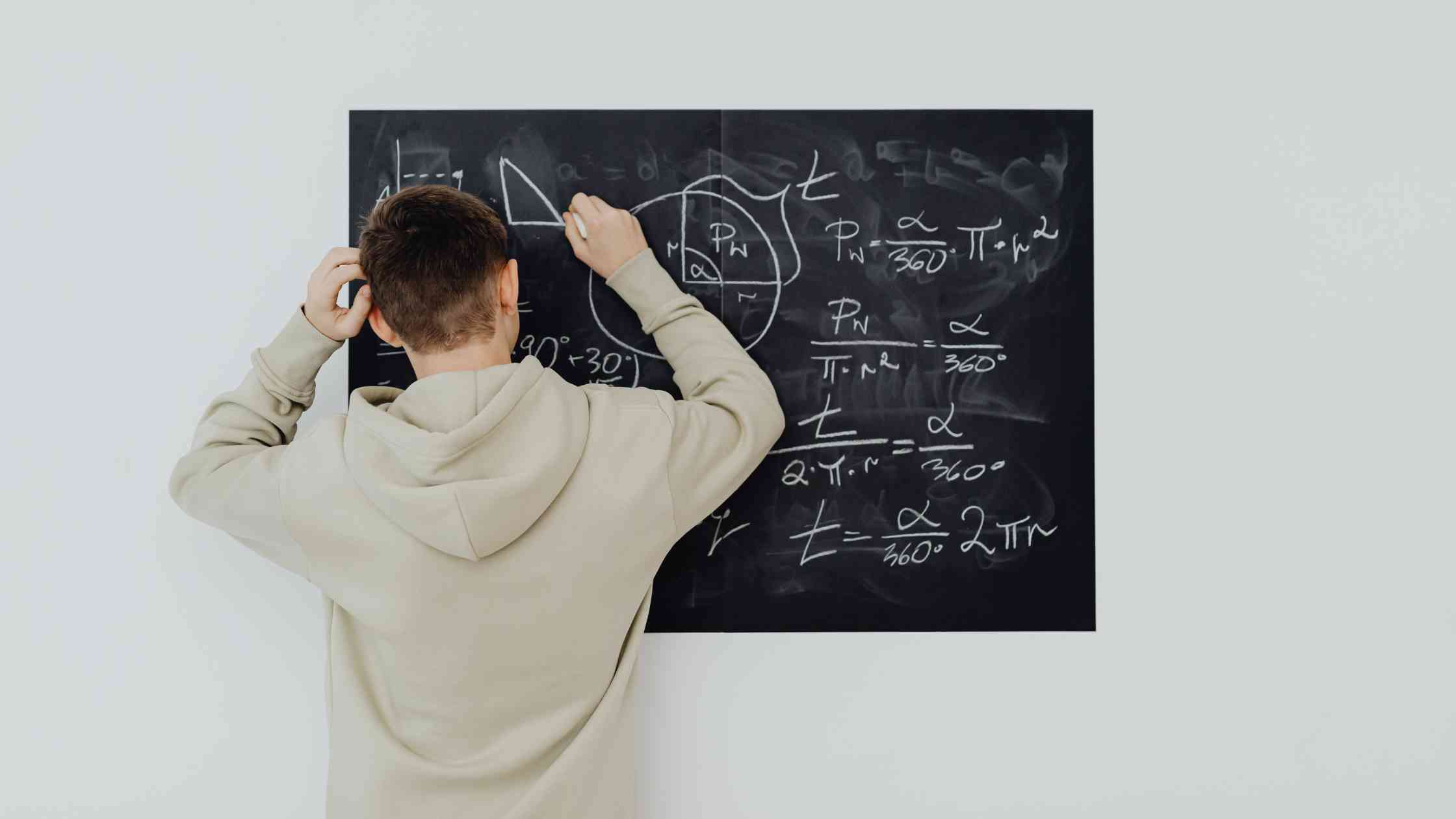 A student solves math equations, illustrating the PSAT’s focus on reasoning, problem-solving, and academic readiness.