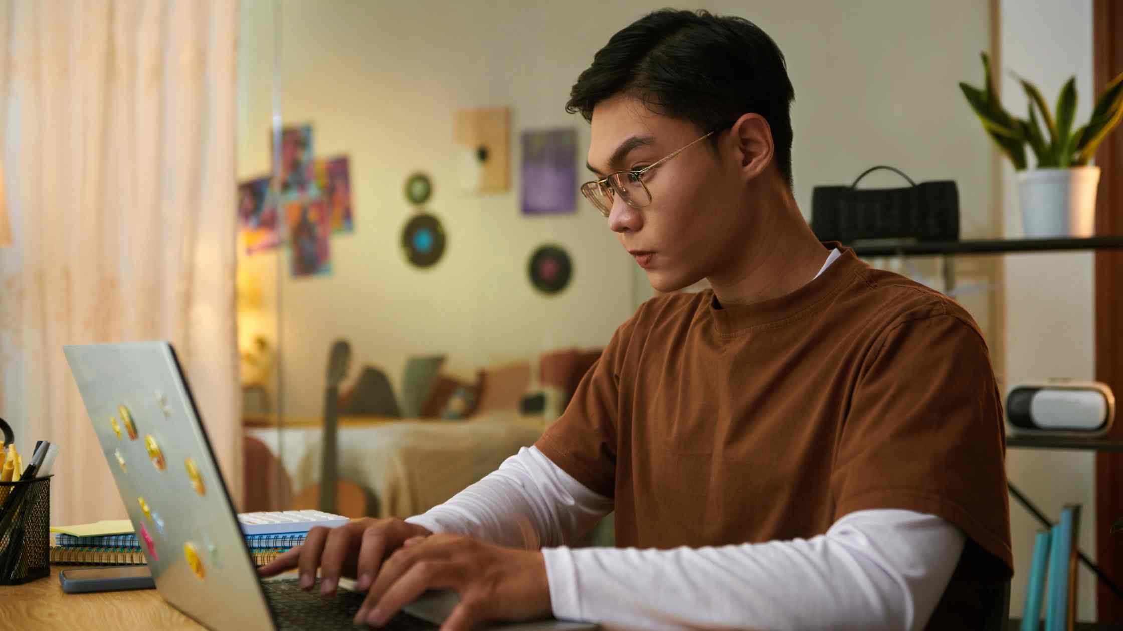 Focused student working on laptop, representing key guidance about SAT scores and navigating the college admissions process.
