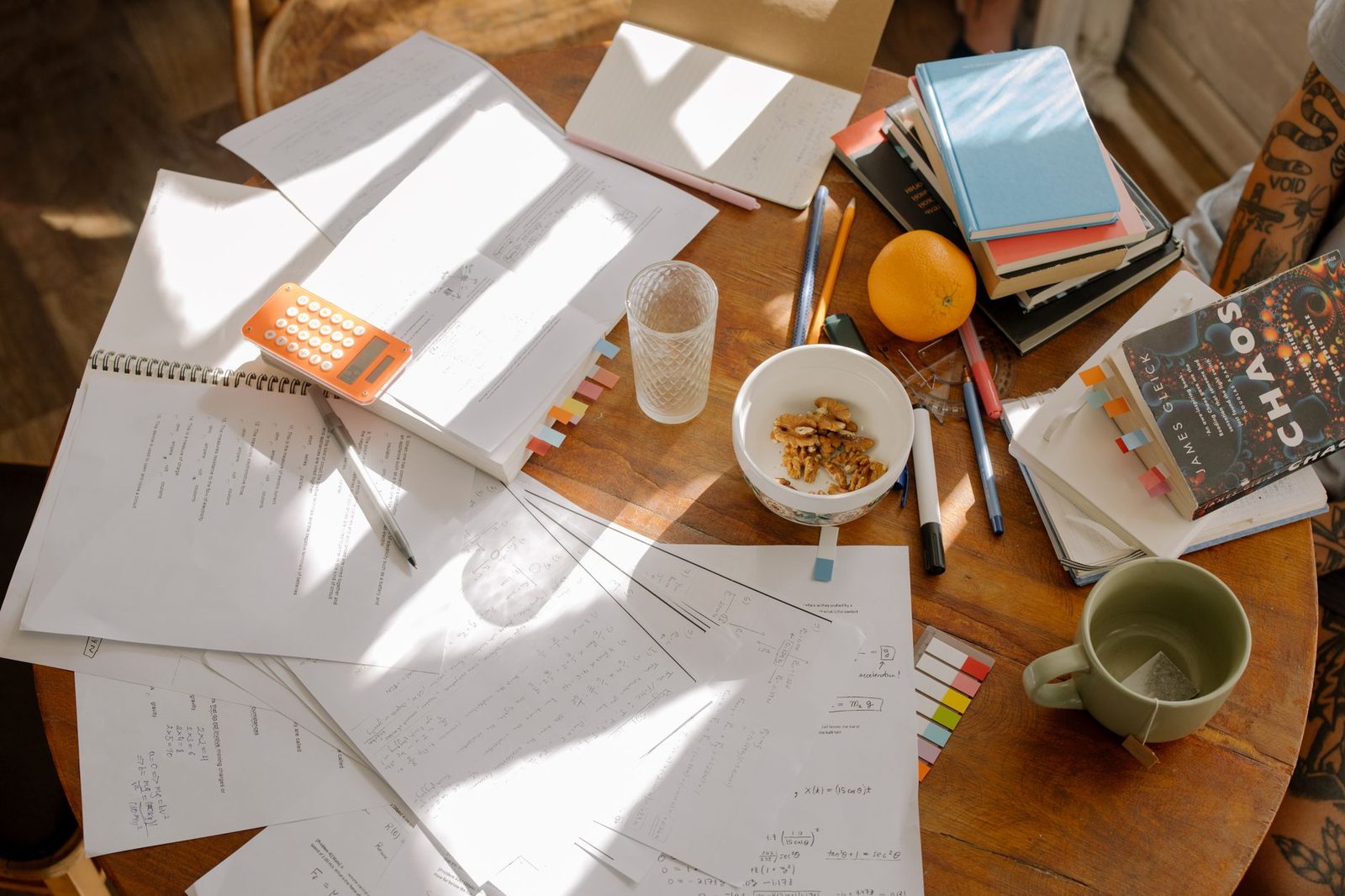 Student organizing a study schedule at a desk