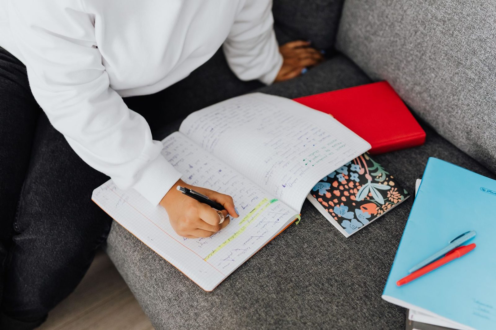 Student organizing study materials and notes for exam preparation