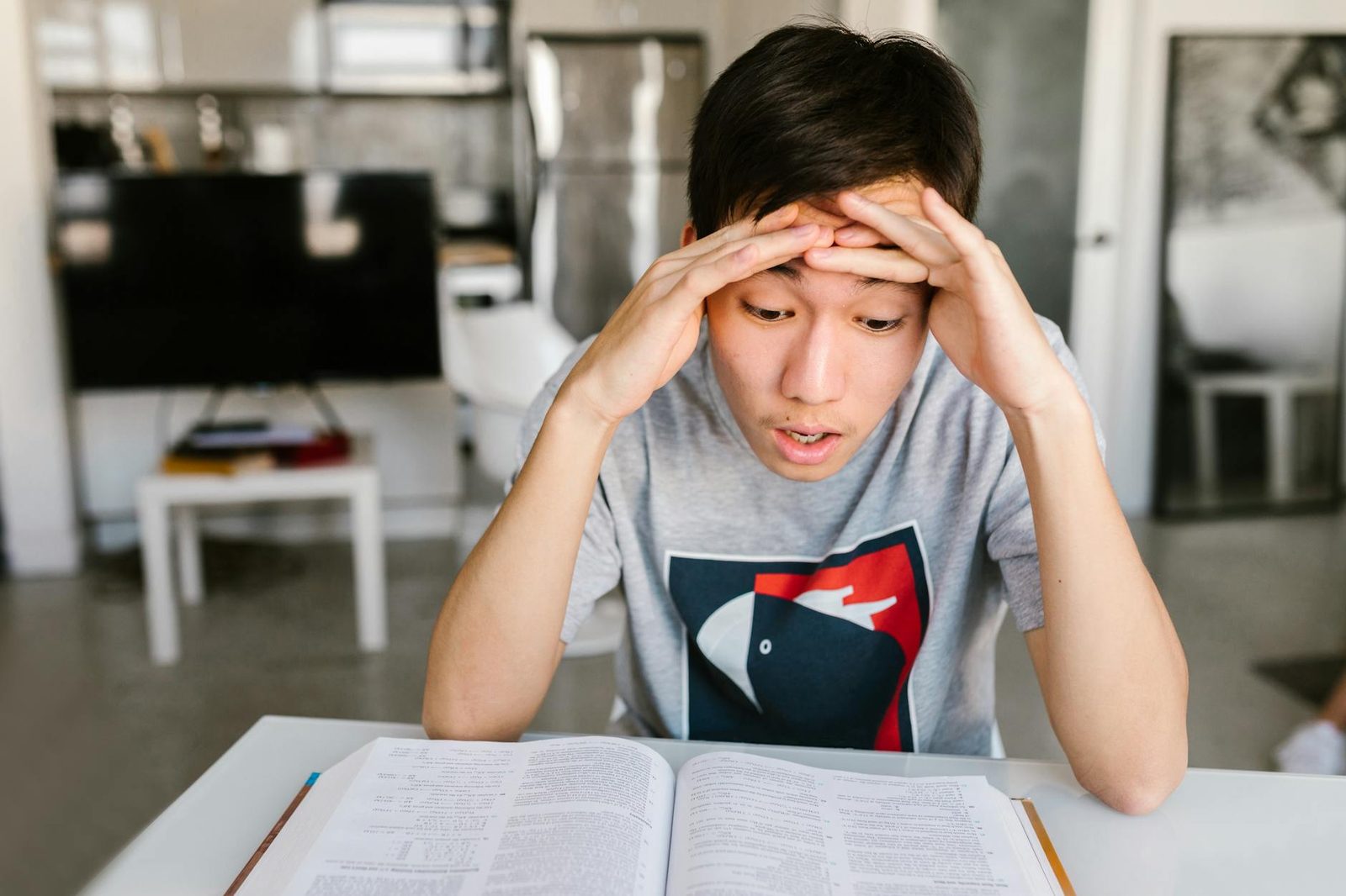 Student looking frustrated while studying at a desk