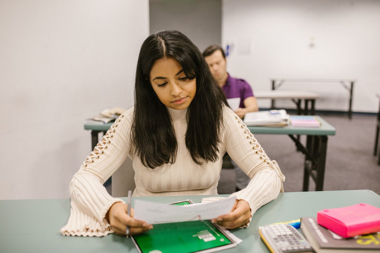Student carefully reviewing and editing a written draft