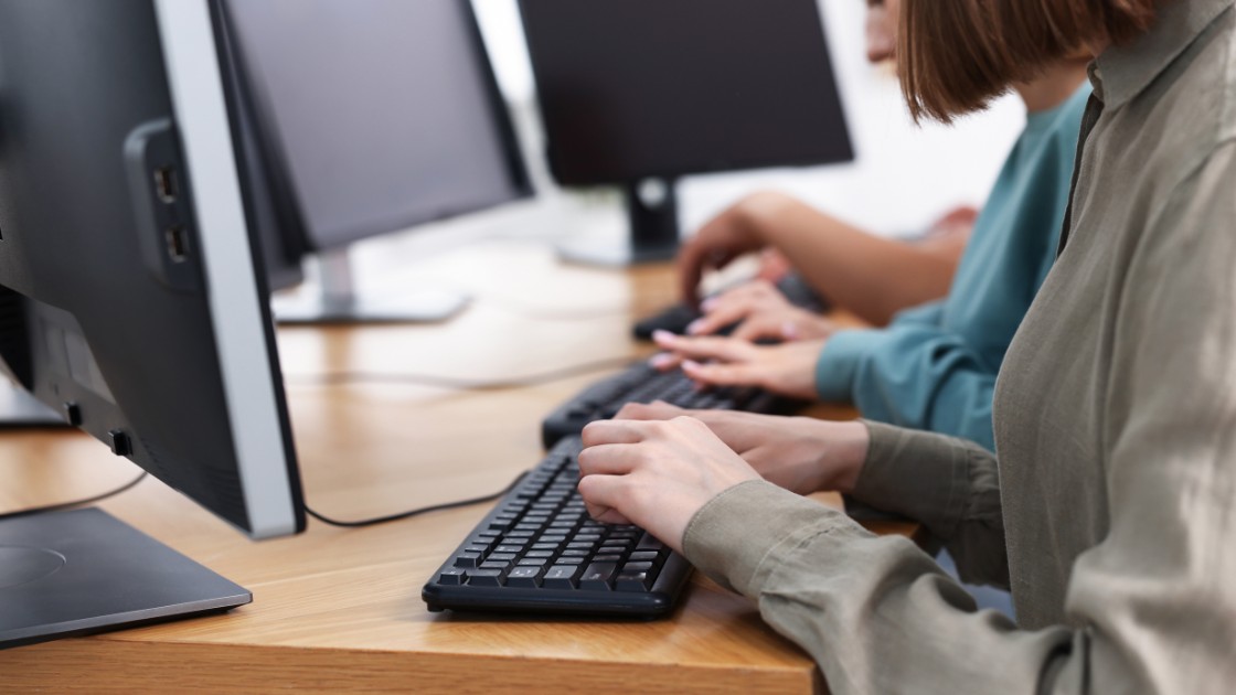 Students taking the Digital SAT on desktop computers, reflecting the real test day experience with on-screen tools & timing.