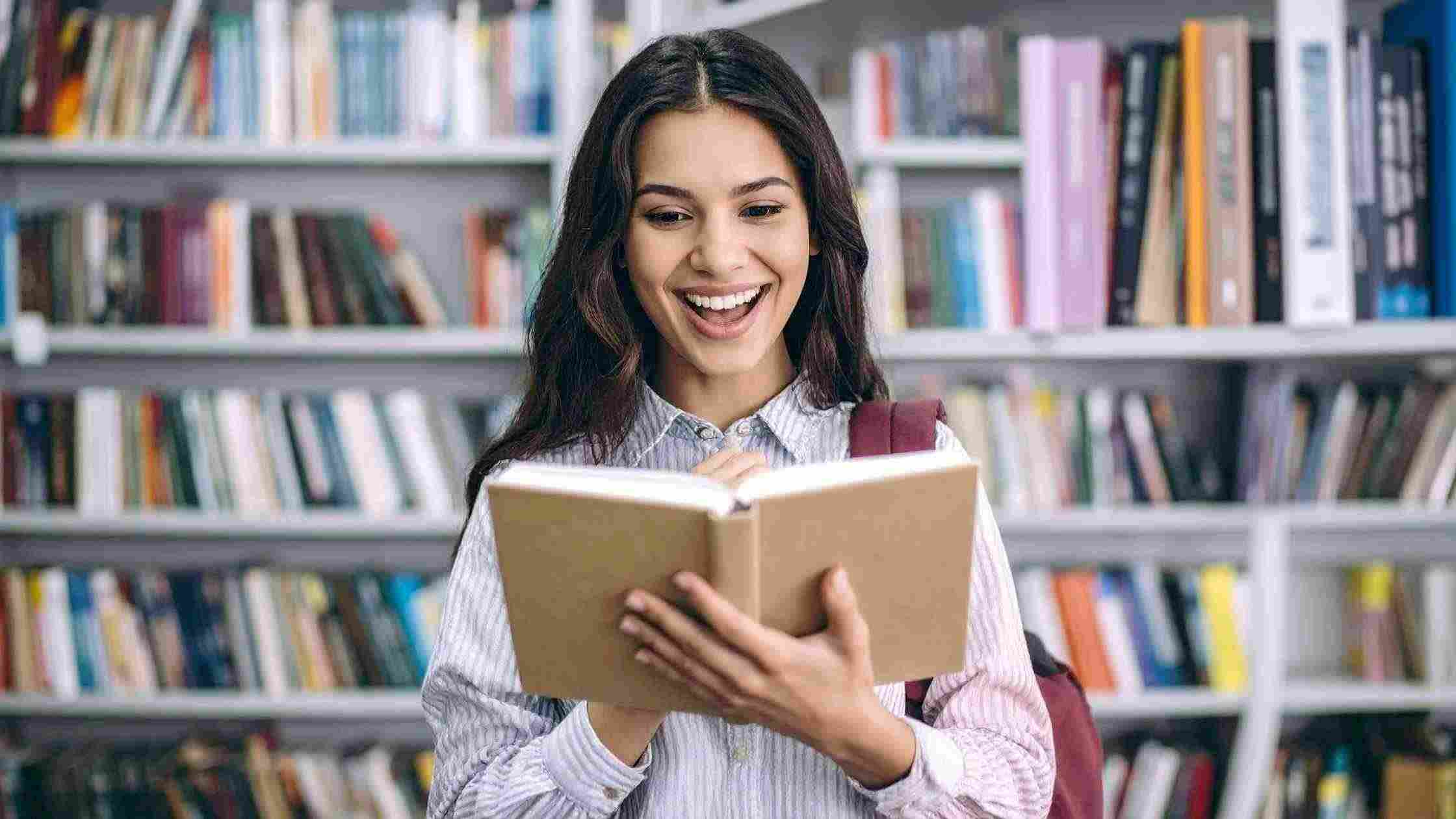 A student reading a book in a library, shows global SAT coaching access and learning opportunities for students worldwide.