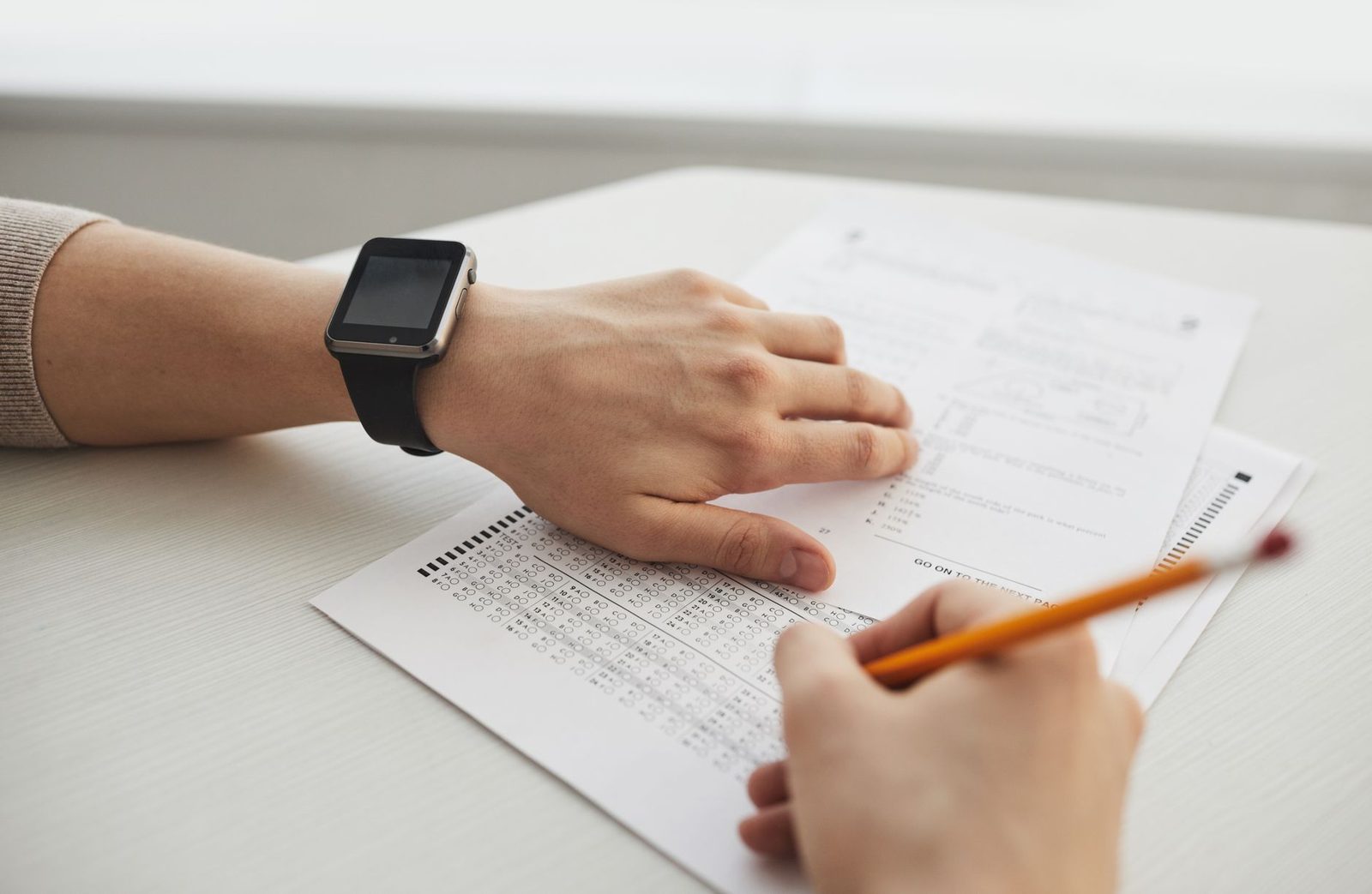 Student taking a timed practice test at a desk